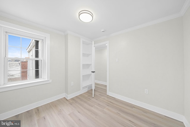 unfurnished bedroom with light wood-style floors, baseboards, and ornamental molding