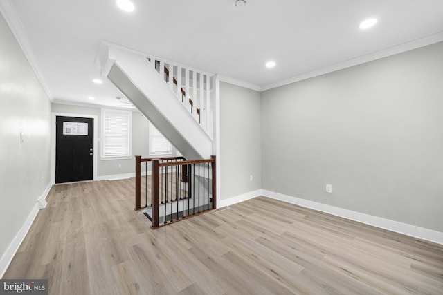 entrance foyer with recessed lighting, baseboards, crown molding, and light wood-style floors