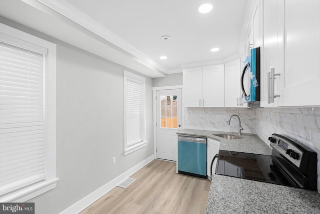 kitchen featuring backsplash, light stone countertops, dishwashing machine, stainless steel electric range, and a sink