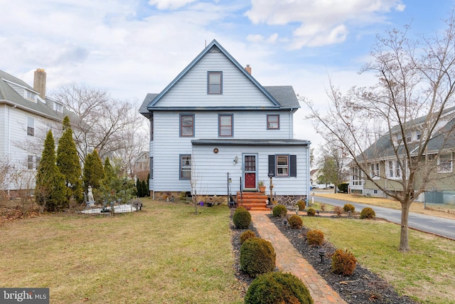 view of front facade with a front lawn and a chimney