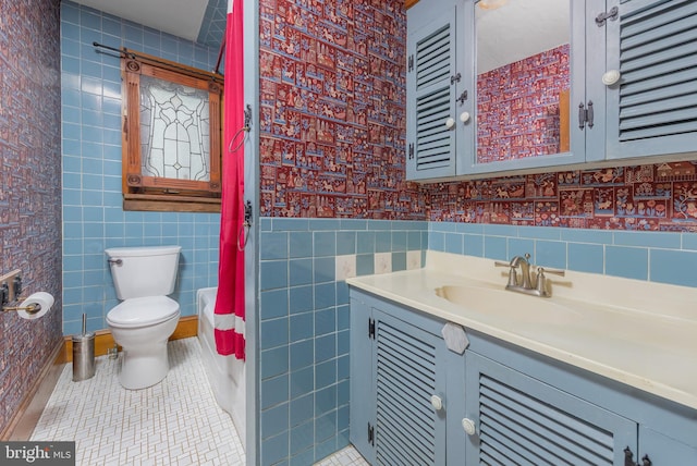 full bath featuring tile patterned floors, toilet, tile walls, wallpapered walls, and vanity