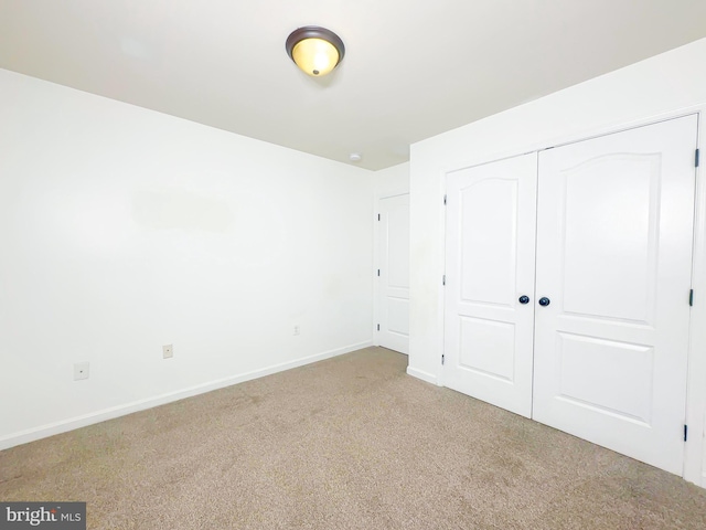 2204 Holly Oak Ct, Waldorf, MD 20601 - unfurnished bedroom featuring a closet, baseboards, and carpet