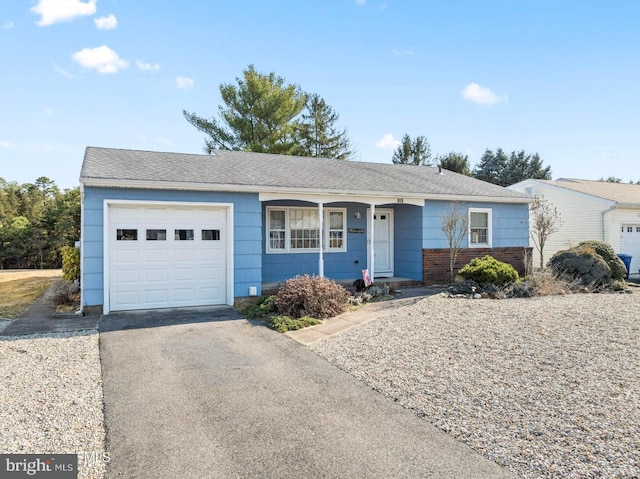 ranch-style house with an attached garage and driveway