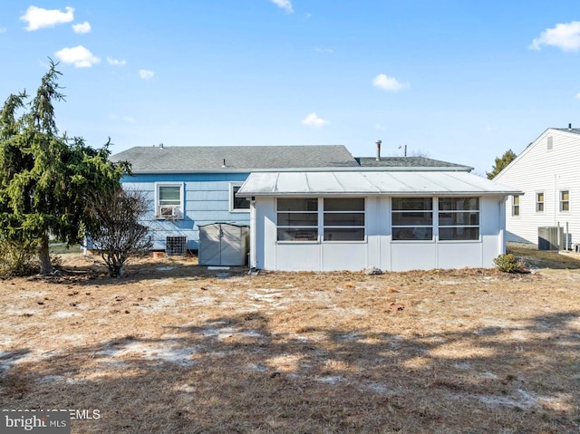 rear view of property with central AC