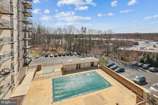 view of swimming pool featuring fence