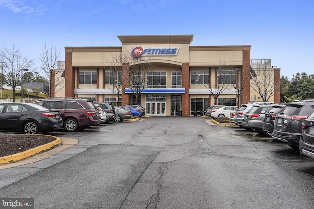 view of building exterior with uncovered parking