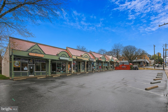 view of building exterior with uncovered parking