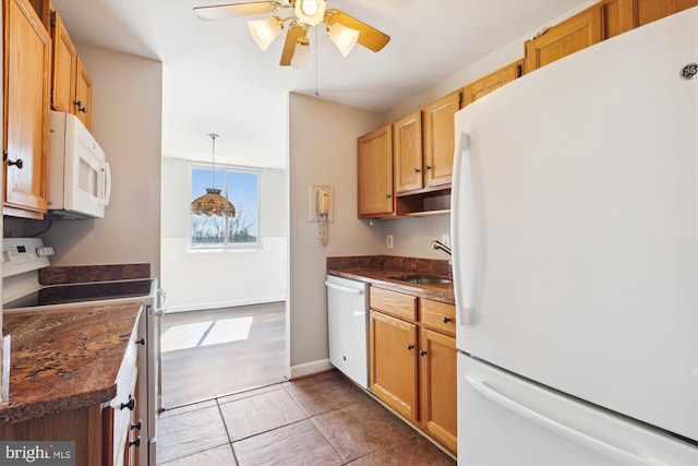 kitchen featuring ceiling fan, white appliances, dark countertops, and a sink