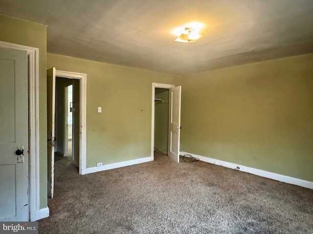 unfurnished bedroom with baseboards and carpet