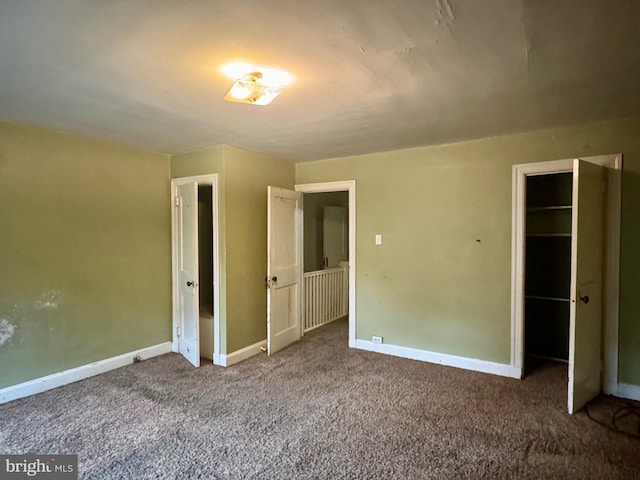 unfurnished bedroom with baseboards and carpet