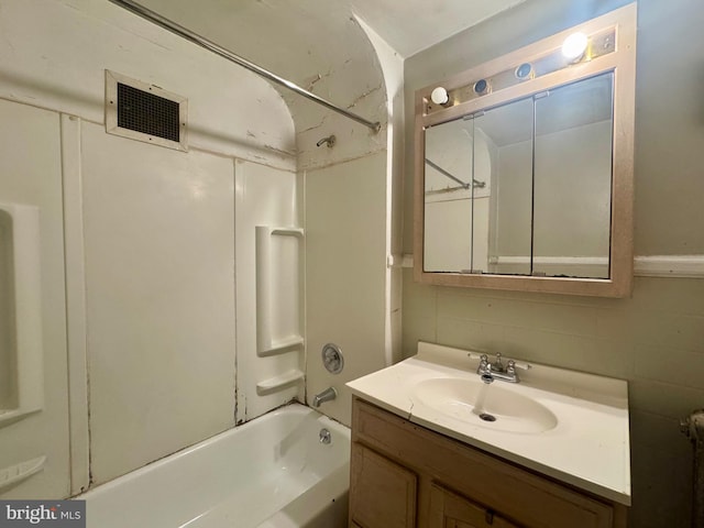 full bath with vanity, bathtub / shower combination, and visible vents