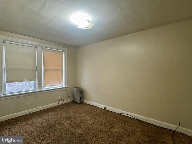 empty room featuring radiator heating unit, baseboards, and carpet floors