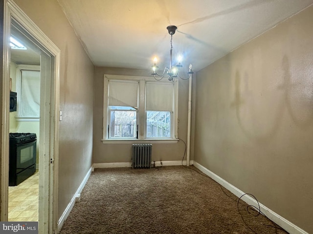 unfurnished dining area with a notable chandelier, radiator, baseboards, and carpet