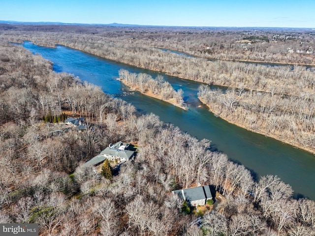 aerial view featuring a water view and a wooded view