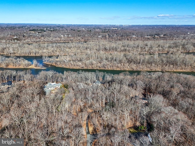 bird's eye view featuring a wooded view and a water view