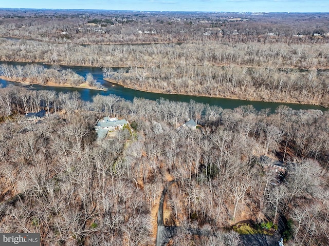 drone / aerial view with a water view and a wooded view