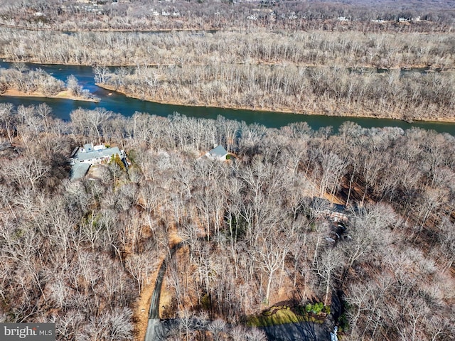 aerial view with a forest view and a water view