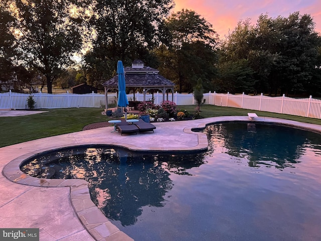 pool at dusk featuring a gazebo, a patio area, a fenced in pool, and a fenced backyard