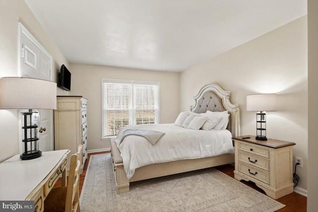 bedroom with baseboards and dark wood-style floors