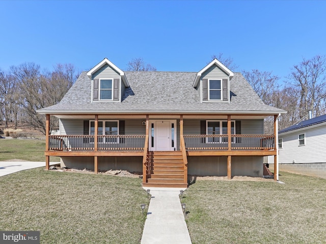 view of front facade featuring covered porch, a front yard, and roof with shingles