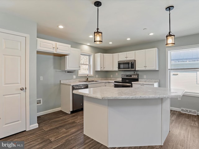 kitchen with dark wood finished floors, visible vents, white cabinetry, and stainless steel appliances