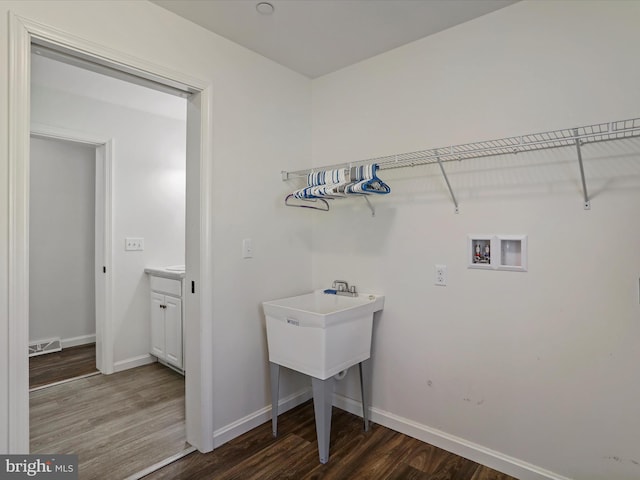 laundry area featuring visible vents, washer hookup, wood finished floors, baseboards, and laundry area