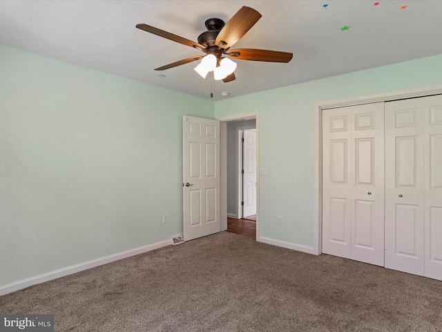 unfurnished bedroom with visible vents, ceiling fan, baseboards, carpet, and a closet