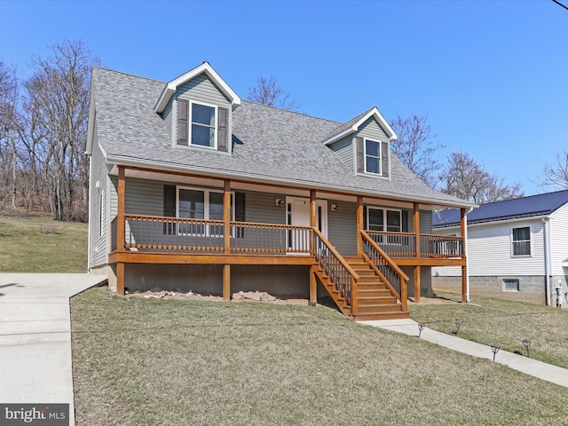 view of front facade featuring stairway, roof with shingles, a porch, and a front yard