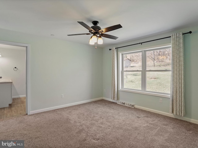 unfurnished bedroom featuring carpet flooring, baseboards, and visible vents