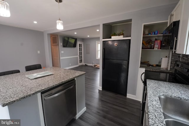 kitchen featuring light stone countertops, black appliances, dark wood-style flooring, and white cabinetry