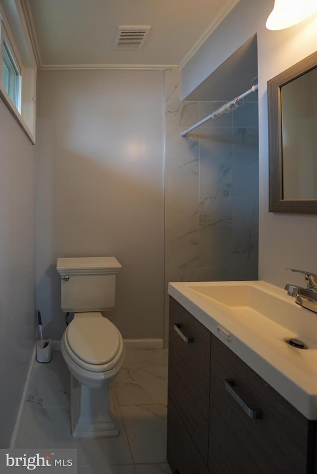 bathroom with vanity, visible vents, crown molding, toilet, and marble finish floor