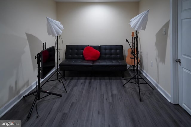 living area with baseboards and wood finished floors