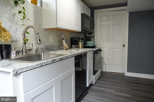 kitchen featuring dark wood-type flooring, black appliances, a sink, backsplash, and white cabinetry