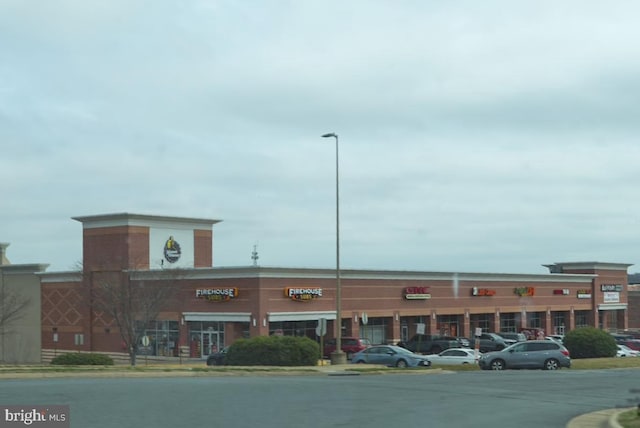 view of building exterior with uncovered parking