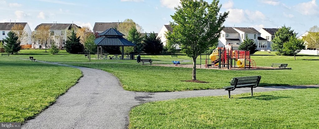 view of property's community featuring a gazebo, playground community, a residential view, and a lawn