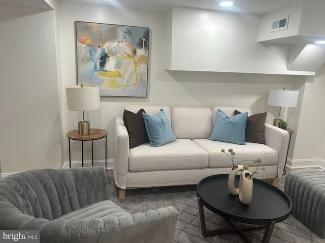 living room with recessed lighting, visible vents, baseboards, and radiator heating unit