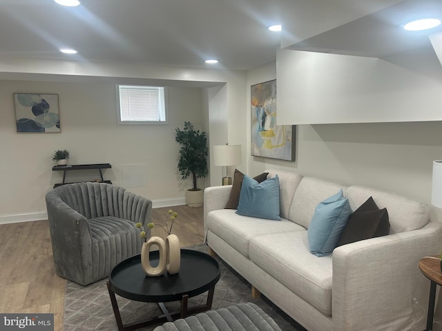 living area featuring recessed lighting, baseboards, and wood finished floors