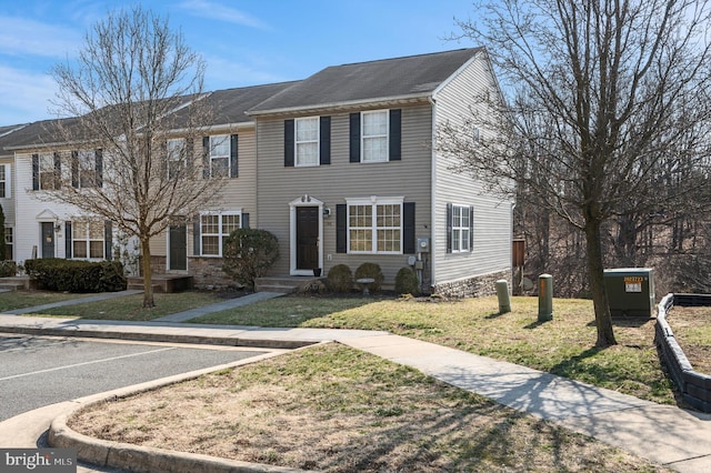 view of front of house with uncovered parking and a front lawn