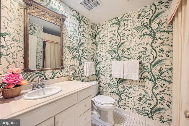 bathroom featuring visible vents, toilet, wallpapered walls, tile patterned flooring, and vanity