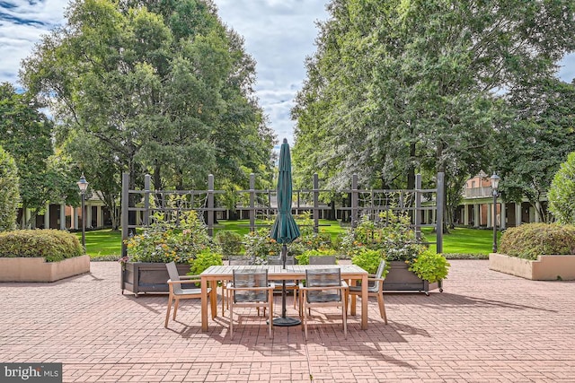 view of patio / terrace with outdoor dining space and fence