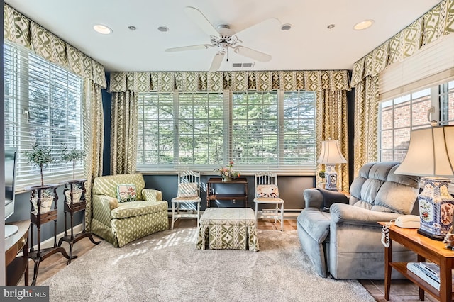 interior space with a healthy amount of sunlight, visible vents, baseboard heating, and ceiling fan