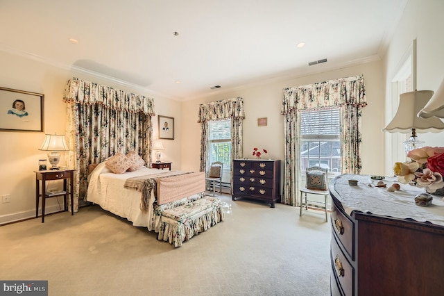 bedroom with visible vents, light colored carpet, crown molding, and baseboards