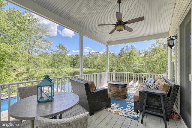 wooden deck featuring an outdoor living space, outdoor dining area, and ceiling fan