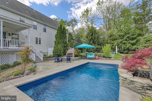 pool featuring a patio, area for grilling, and stairs