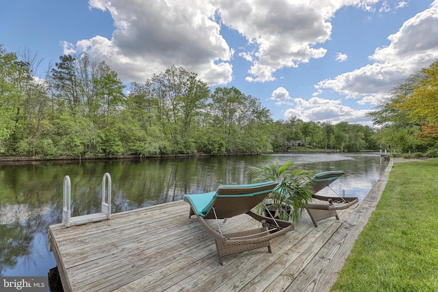 view of dock featuring a forest view and a water view