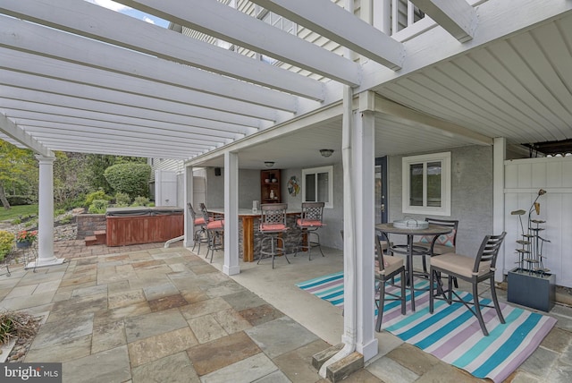 view of patio with outdoor dining space, outdoor dry bar, a pergola, and a hot tub