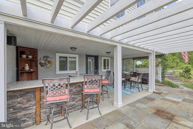 view of patio featuring outdoor dry bar and outdoor dining space