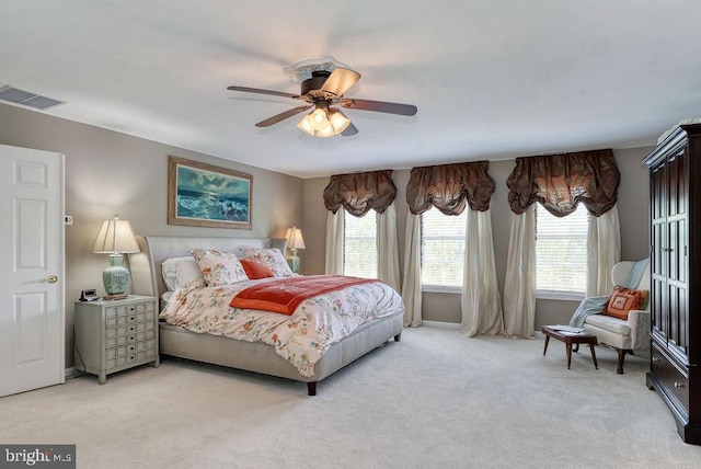 bedroom featuring visible vents, light colored carpet, and ceiling fan