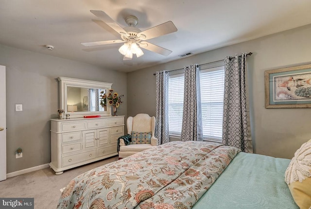 bedroom featuring ceiling fan, baseboards, visible vents, and light carpet