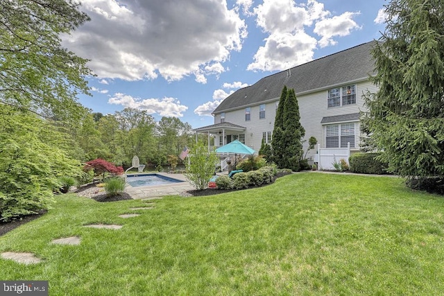 view of yard featuring an outdoor pool and a patio